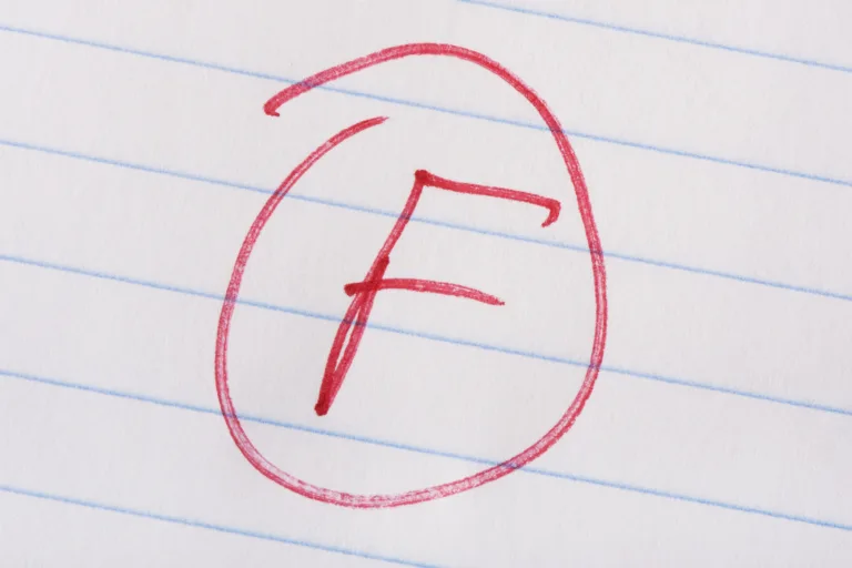 "F" grade written in red pen on notebook paper.