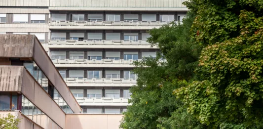 Picture of the main Slovenian hospital, univerzitetni klinicki centar ljubljana, the university clinical centar, zith a focus on its entrance and its main facade.