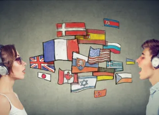 5 prednosti učenja tujega jezika Young woman and man in headphones learning different languages communicating through simultaneous interpretation