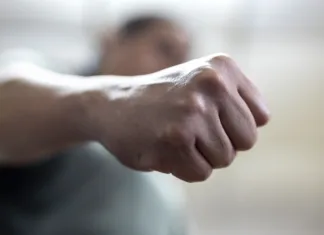 Danes je mednarodni dan boja proti nasilju nad ženskami The angry man clenched his fist. Concept of violence.