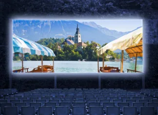 Filmske uspešnice, posnete v Sloveniji Typical wooden boats, called "Pletna", in the Bled Lake with the island of the church (Europe - Slovenia) - Outdoor cinema concept image