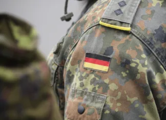 Bodo morali Nemci v vojsko? Jim bomo sledili še mi? Uniform of the German army with the German flag on the shoulder. German military, selective focus.