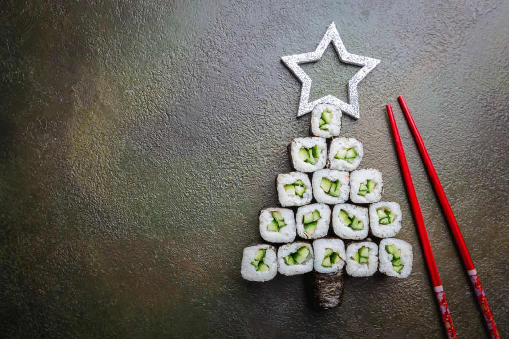 Sushi christmas tree with star over dark background, top view with copy space. Christmas or New Year background