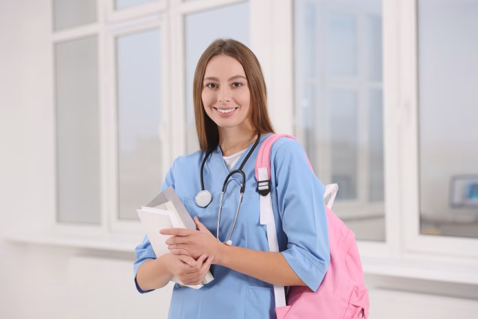 portrait-of-young-intern-wearing-uniform-in-university-hall-stockpack-istock Portrait of young intern wearing uniform in university hall