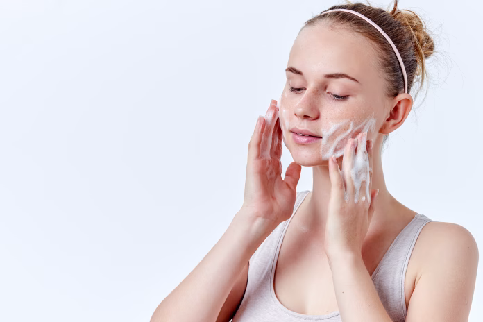 teenager-skincare-beautiful-teenage-girl-with-freckles-and-blue-eyes-using-foaming-cleanser-face-washing-concept-isolated-on-white-background-stockpack-istock Teenager skincare. Beautiful teenage girl with freckles and blue eyes using foaming cleanser. Face washing concept isolated on white background.