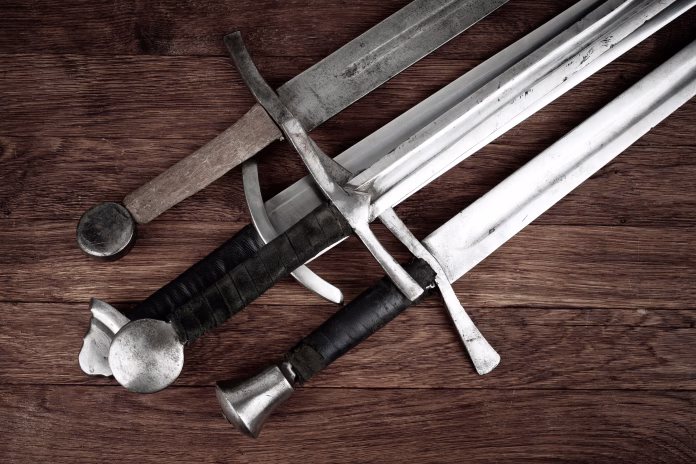 Medieval vintage swords on wooden backgrond.