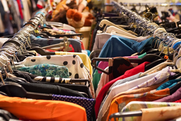 A second hand clothes shop in the center of the city with a lot of clothes