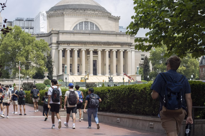 New York, NY, USA - July 8, 2022: Students on the Columbia University campus in the Morningside Heights neighborhood on the Upper West Side of Manhattan, New York City. Steps of the Low Memorial Library in the background are being restored in the summer.