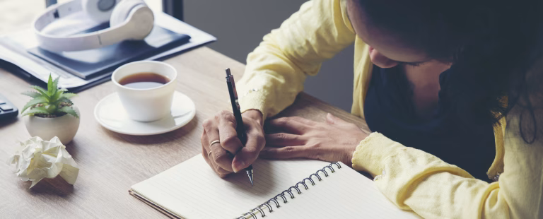 Planner plan Schedule Calendar and reminder agenda, work at home. Man hand planning daily appointment and write business trip in diary book at office desk. 2025 Calendar reminder event concept-banner image.
