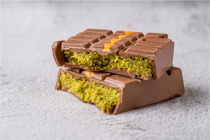 dubai-chocolate-bar-with-green-kadayif-and-peanut-butter-on-white-stone-table-stockpack-istock Dubai Chocolate bar with green kadayif and peanut butter on white stone table