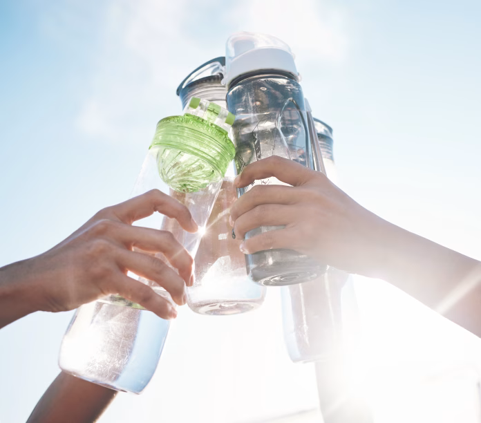 hands-water-bottle-and-toast-to-fitness-together-after-workout-exercise-or-training-outdoor-with-team-of-players-sport-goals-and-cheers-with-group-and-liquid-for-hydration-celebration-and-unity-stockpack-istock Hands, water bottle and toast to fitness together after workout, exercise or training outdoor with team of players. Sport, goals and cheers with group and liquid for hydration, celebration and unity