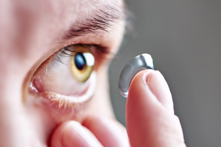 Medicine and vision - young woman with contact lens