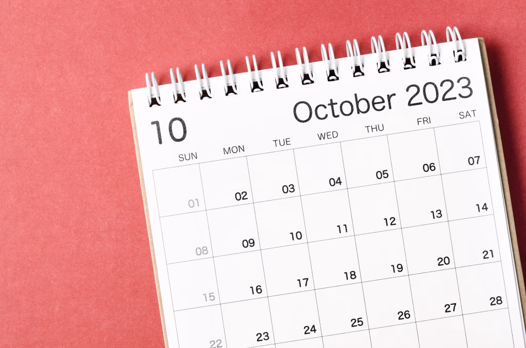 October 2023 calendar desk for the organizer to plan and reminder isolated on red background.