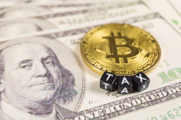 SLOVENIA - December 27, 2018: Bitcoin tax and capital gain or loss for trading on dollat bills