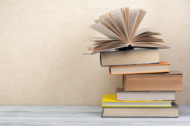 Stack of colorful books. Education background. Back to school. Book, hardback colorful books on wooden table. Education business concept. Copy space for text