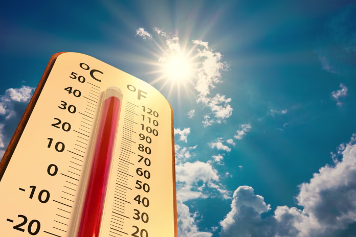 climate change, low angle view Thermometer on blue sky with sun shining in summer show increase temperature, concept global warming
