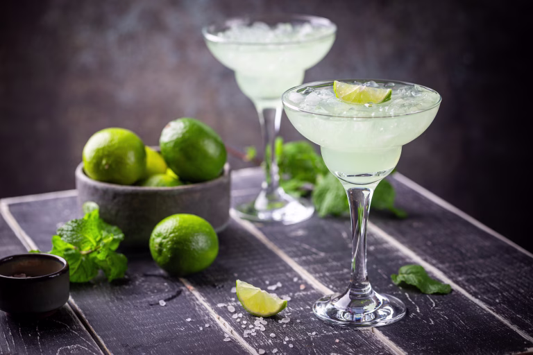 margarita cocktail with lime in a glass on dark background