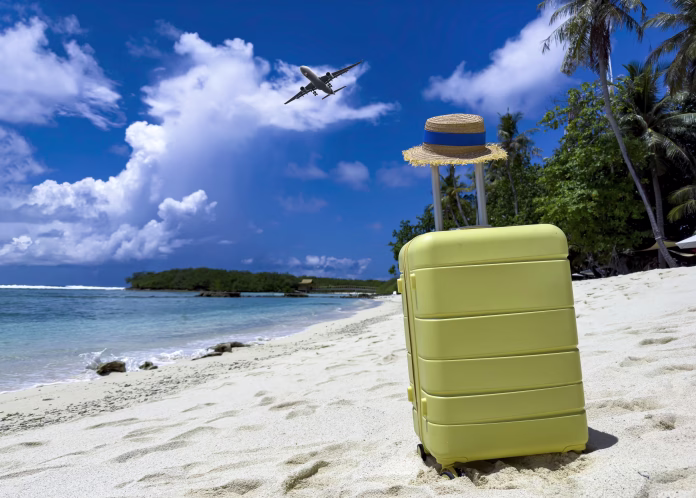 The yellow luggage on the beach- summer travel concept