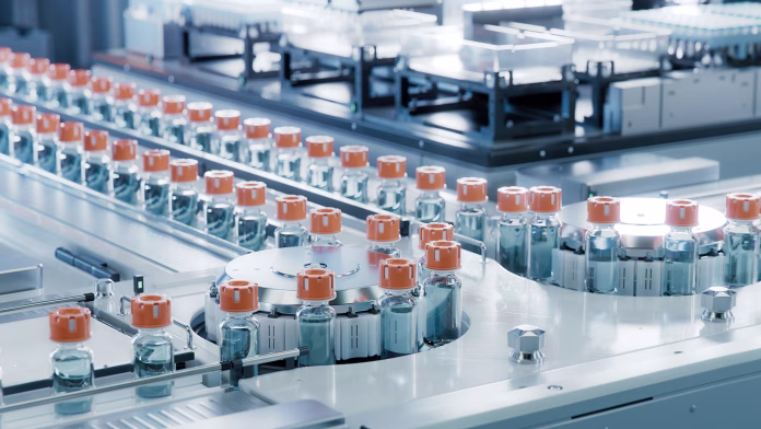 vaccine-production-facility-medication-manufacturing-process-glass-vials-with-orange-caps-on-conveyor-belt-medical-ampoule-production-line-at-modern-pharmaceutical-factory-stockpack-istock Vaccine Production Facility. Medication Manufacturing Process. Glass Vials with Orange Caps on Conveyor Belt. Medical Ampoule Production Line at Modern Pharmaceutical Factory.