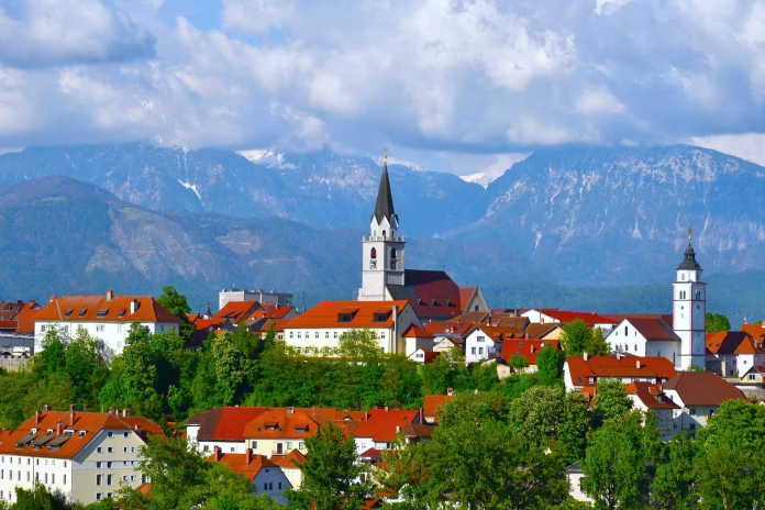 View of the town of Kranj with clouds covered mountain peak behind in Gorenjska, Slovenia