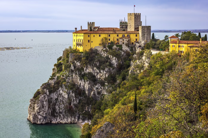Duino Castle overlooking the Gulf of Trieste on the Adriatic Sea. Photo taken on 28th of November 2022 in Duino village, Trieste province, Italy.