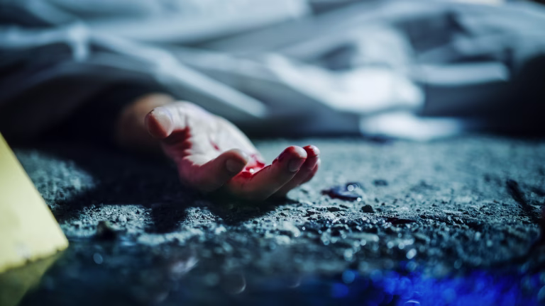 Extreme Close-Up on Victim's Bloody Hand. Still Dead Body Under a Cover and Next to Numbered Markers. Spilled Blood on the Floor Suggests a Violent and Shocking Crime of Passion in Urban City