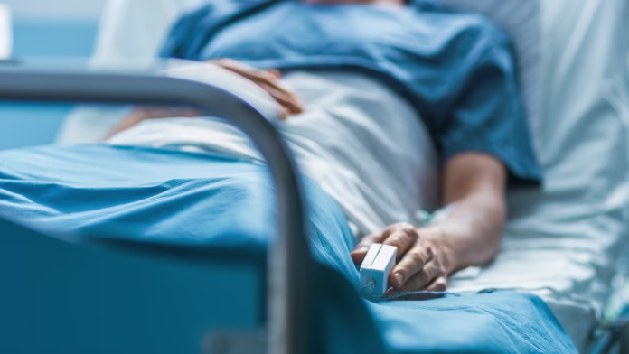 in-the-hospital-sick-male-patient-sleeps-on-the-bed-heart-rate-monitor-equipment-is-on-his-finger-stockpack-istock In the Hospital Sick Male Patient Sleeps on the Bed. Heart Rate Monitor Equipment is on His Finger.