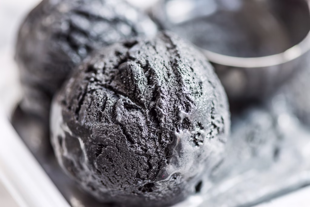 Scoops of Homemade Black Charcoal Coconut Ice Cream the Container
