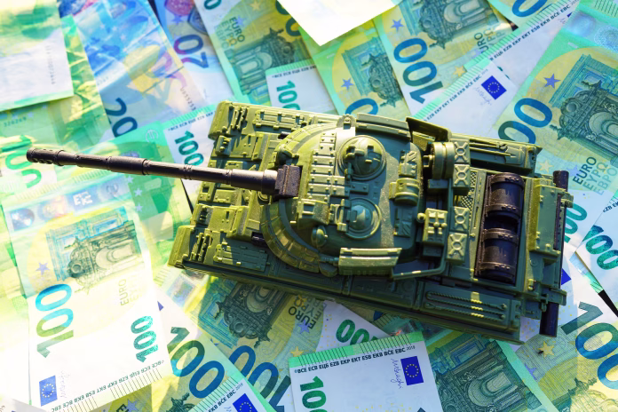 Tank on background of banknotes. Currency war. War costs, military spending. Making money from war. Money laundering on War. Military economy. Military tank and European banknotes. Weapons trade.