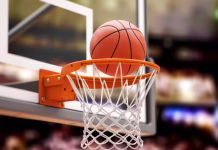 Koliko možnosti Sloveniji na Eurobasketu pripisujejo stavnice? Basketball ball scoring the winning points on basketball net hoop on basketball arena. 3d illustration