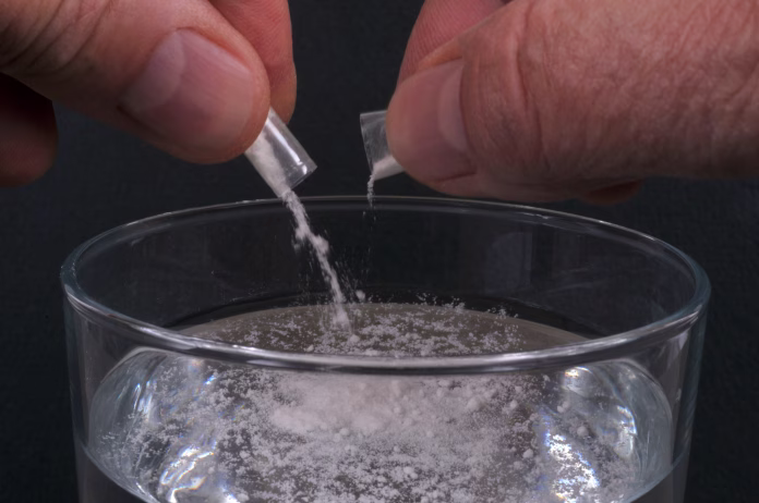 Concept of pouring GHB into a glass with the powder of a capsule