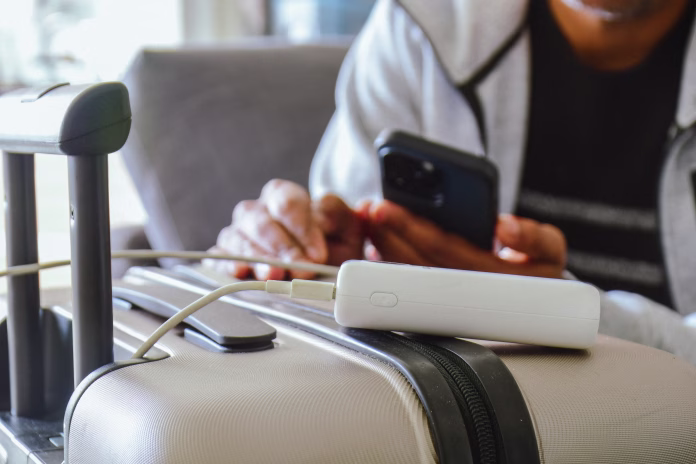 cropped-image-of-a-south-asian-man-waiting-in-airport-lounge-charging-his-phone-using-power-bank-before-departure-focus-on-the-foreground-stockpack-istock Cropped image of a South Asian man waiting in airport lounge charging his phone using power bank before departure. Focus on the foreground.