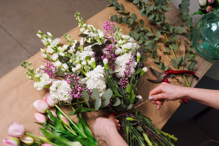 female-florist-makes-a-bouquet-in-a-flower-shop-spring-bouquet-stockpack-istock female florist makes a bouquet in a flower shop, spring bouquet