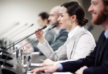 Svet vlade Republike Slovenije za mladino išče nove člane One of young politicians speaking in microphone among other participants of conference