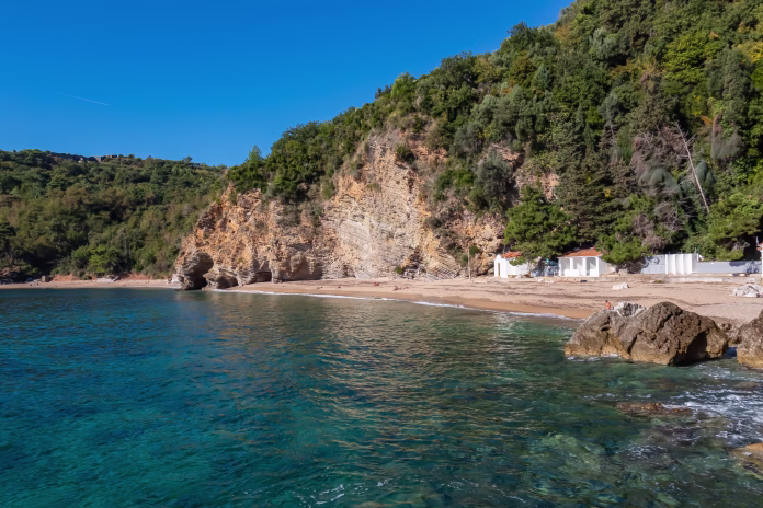 Panoramic view of the Mogren beach in the tourist coastal city of Budva, Montenegro, Adriatic Mediterranean Sea, Montenegro, Balkan, Europe. Coastline of Budvanian riviera. Summer vacation atmosphere