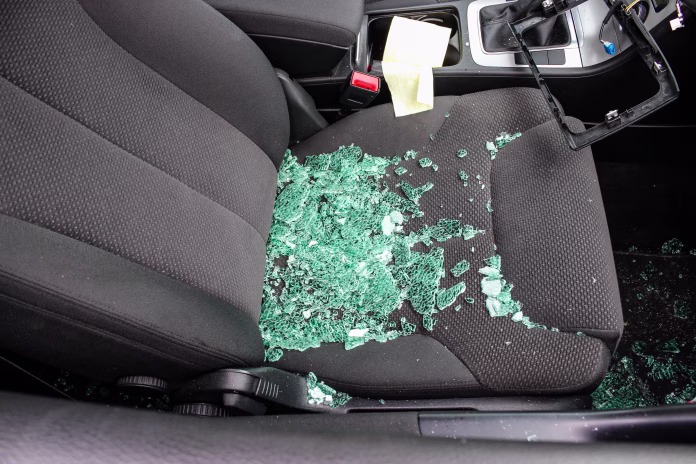 the photo shows the effects of vandalism by thieves of car radios, a broken car window