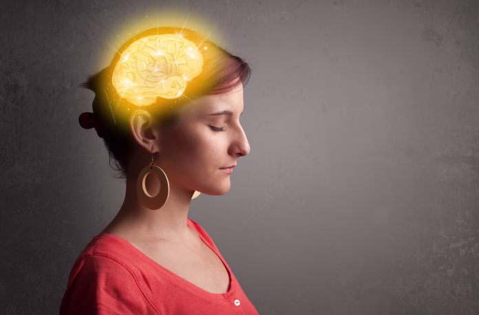 Young girl thinking with glowing brain illustration on grungy background