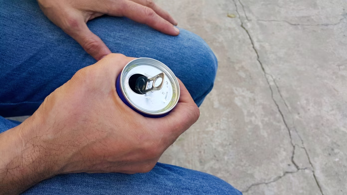 a-man-holds-an-aluminum-can-with-a-drink-close-up-stockpack-istock A man holds an aluminum can with a drink, close-up.