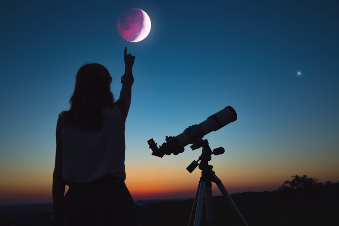 Girl looking at lunar eclipse through a telescope. My astronomy work.