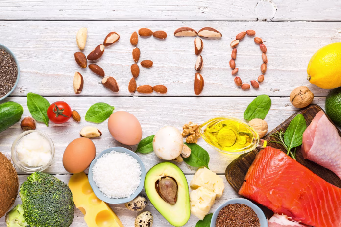 Keto diet concept. Ketogenic diet food. Balanced low-carb food background. Vegetables, fish, meat, cheese, nuts on wooden background. top view