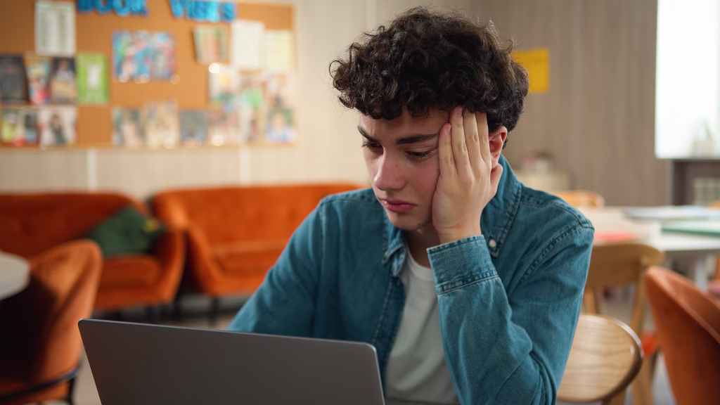 Tired stressed headache overworked sad upset Caucasian male student guy pupil boy teen teenager studying laptop learning online education internet homework prepare to exams school college university. High quality 4k footage