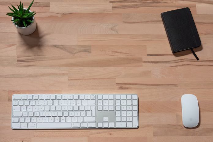 workspace-of-modern-white-wireless-keyboard-wireless-mouse-and-notebook-on-wooden-table-with-green-plant-top-view-with-copy-space-flat-lay-as-a-background-with-copy-space-stockpack-istock workspace of modern white wireless keyboard, wireless mouse and notebook on wooden table with green plant. top view with copy space. flat lay as a background with copy space