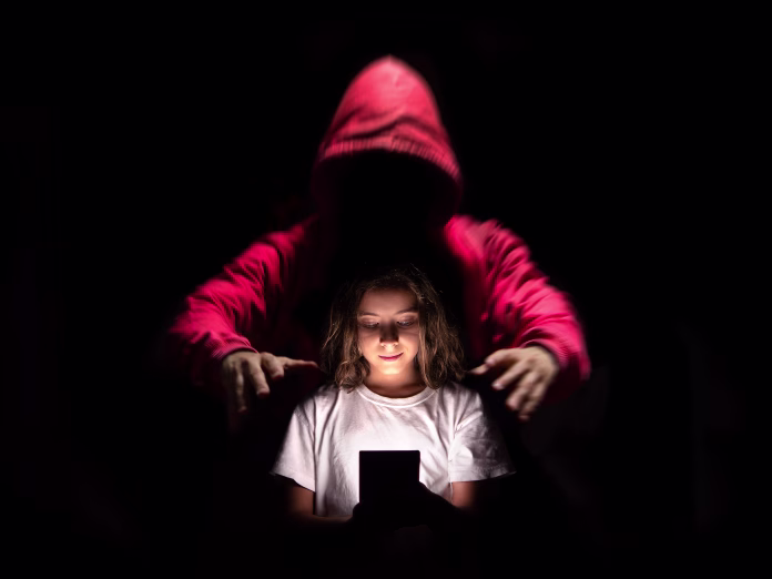 a-girl-using-her-cell-phone-on-social-networks-without-being-aware-of-the-dangers-they-can-have-stockpack-istock A girl using her cell phone on social networks without being aware of the dangers they can have.