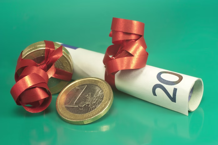 euro banknotes and coins wrapped as a gift