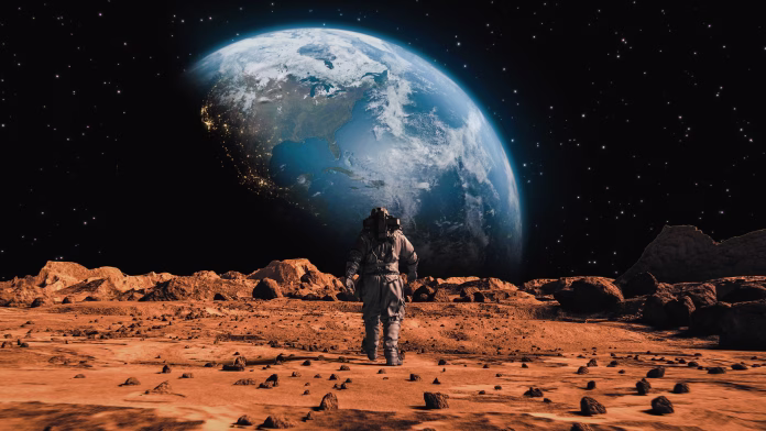 Following Shot of Brave Astronaut in Space Suit Confidently Walking on Mars Towards Earth Planet. Earth Planet as viewed from Mars surface. The surface of Mars, strewn with small rocks and red sand. Martian landscape in rusty orange shades, Mars Planet surface, Desert, Cliffs, sand. Red planet mars. Alien Red Planet Covered in Rocks. First Astronaut On the Mars. Big Moment for the Human Race. Advanced Technologies, Space Exploration/ Travel, Colonization Concept.