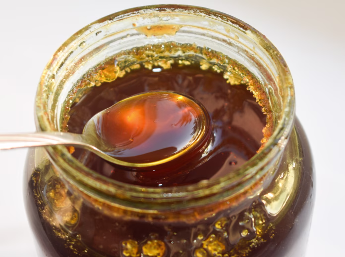 fresh-honey-is-poured-into-a-glass-jar-close-up-selective-focus-and-blurred-background-taking-a-spoon-of-honey-from-jar-top-view-photo-stockpack-istock Fresh honey is poured into a glass jar. close-up, selective focus and blurred background. Taking a spoon of honey from jar top view photo