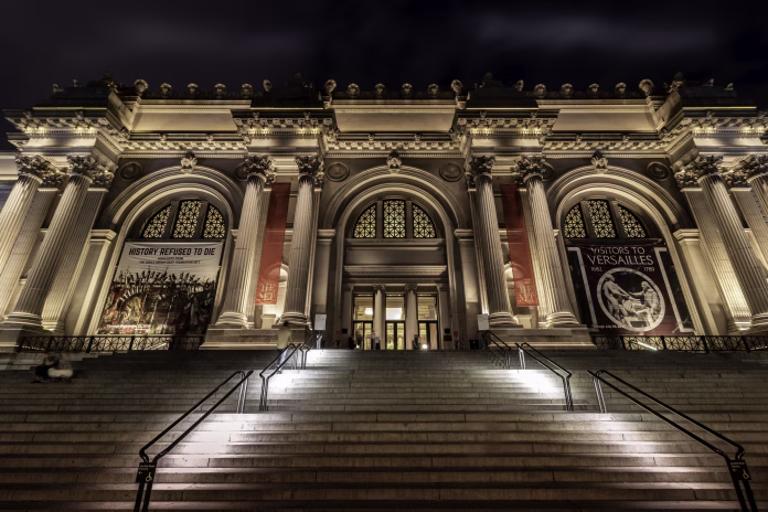 The Metropolitan Museum of Art, shown here at night, is on Fifth Avenue in New York City's Upper East Side. A new lighting design in 2015 beautifully shows off the Beaux-Arts facade of the museum after dark.
The facade of the central building, seen here, was designed by Richard Morris Hunt and was opened to the public in 1902. The north and south wings were added a few years later, designed by Charles Follen McKim for the firm of McKim, Mead, and White in the same neoclassical, Beaux Arts style as the center building.