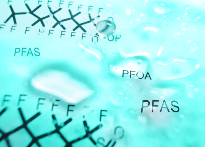 water-droplets-with-pfas-text-and-chemical-structure-in-the-background-contaminated-drinking-water-concept-stockpack-istock Water droplets with PFAS text and chemical structure in the background -- contaminated drinking water concept