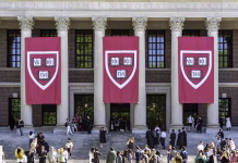 Katere so največje univerze na svetu? Cambridge, MA May 26 2025: Three huge “Veritas” Banners hang from the facade of Widener Memorial Library. Some graduating students are having their photos taken in academic regalia ahead of actual graduation later in the week.
Harvard is an open campus, and the public are normally welcome to stroll and photograph on campus.
The Harry Elkins Widener Memorial Library, situated in Harvard Yard, stands as Harvard University's flagship library and a central hub for research in the humanities and social sciences.
The library was established in memory of Harry Elkins Widener, a Harvard alumnus from the Class of 1907 and an avid book collector who tragically perished in the sinking of the RMS Titanic in 1912.
Designed in the Beaux-Arts style by the architectural firm Horace Trumbauer & Associates, the library's chief designer was Julian Abele, one of the first professionally trained African-American architects in the United States. The building replaced the earlier Gore Hall and features a grand staircase flanked by parapet walls, leading to an imposing façade adorned with classical columns .