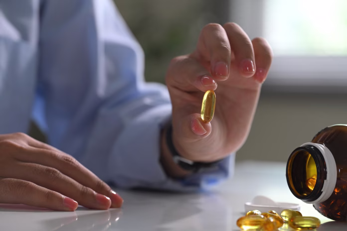 close-up-of-hand-holding-a-softgel-fish-oil-capsule-health-and-nutrition-concept-stockpack-istock Close up of hand holding a softgel fish oil capsule. Health and nutrition concept.